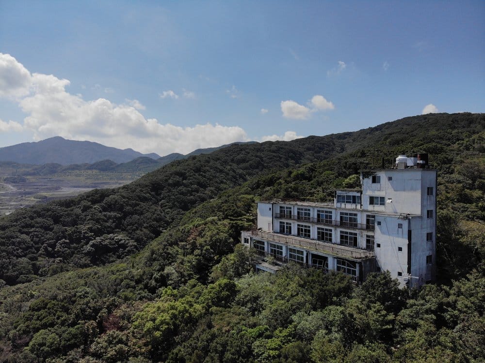 Urbex Abandoned Hotel in Japan surrounded with trees